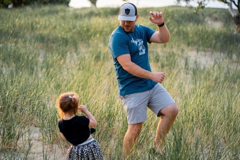 4 Mental Health Hacks Remote WordPress Professionals Can Start Right Now! 4 man dancing in a field with his daughter